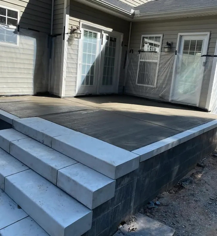 Concrete patio steps beside a home